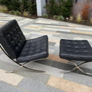 Black leather upholstered Barcelona style chair and footstool.